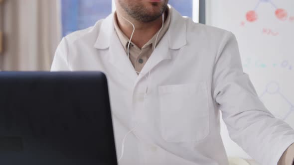 Chemistry Teacher with Laptop Having Online Class