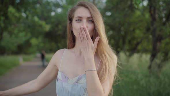 Close-up of Grey-eyed Brunette Woman Sending Air Kiss at Camera. Portrait of Beautiful Young