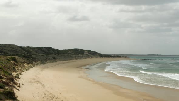 An empty beach on a windy day. PAN RIGHT.