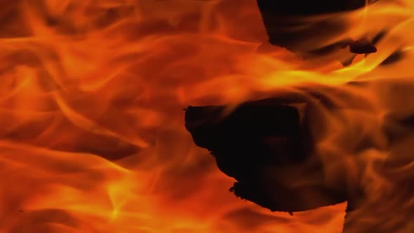 Full frame vertical: Orange flames of wood fireplace blaze hot fire