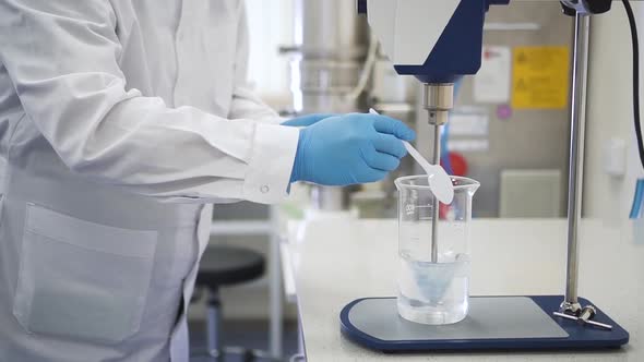 Man Scientist Testing Chemical Mixing Stirrer alt