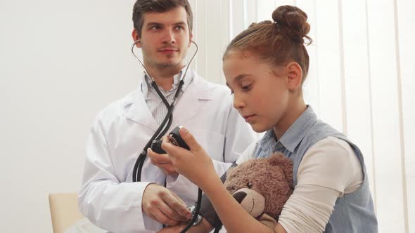 An Experienced Doctor Measures Her Patient's Blood Pressure
