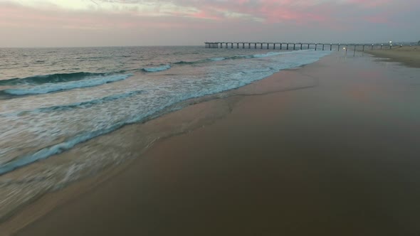 Aerial shot of waves breaking on the beach.