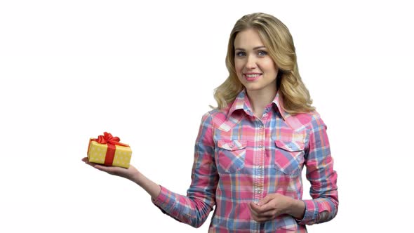 Charming Woman Pointing on Gift Box in Her Hand