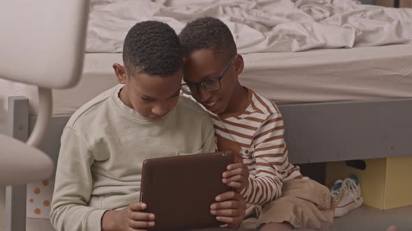 African American Twin Boys Using Digital Tablet
