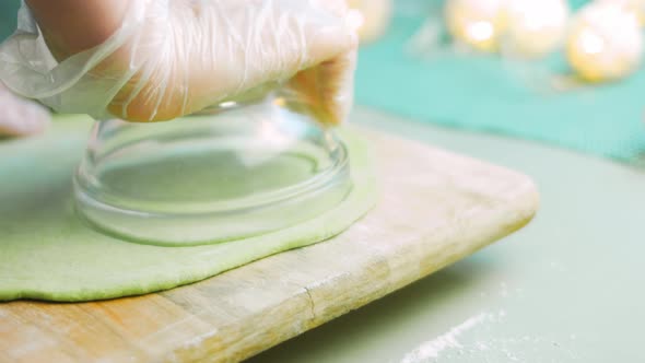 The Chef Forms Round Dough From the Green Dough with a Transparent Bowl