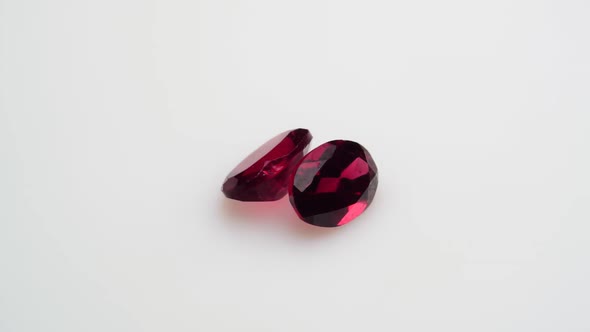 Natural Red Garnet Gemstone on the White Background on the Turning Table