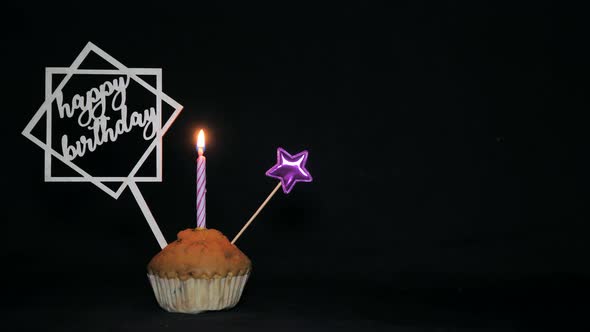 Festive Cupcake with a Candle on a Black Background  Happy Birthday