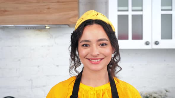 Close Up Smiling Beautiful Woman Housewife Looking at Camera in Home Kitchen