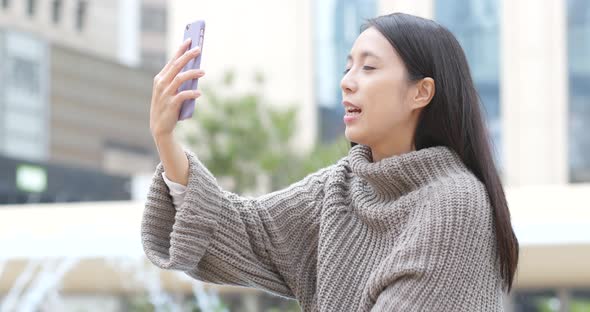 Woman talk to mobile phone at outdoor