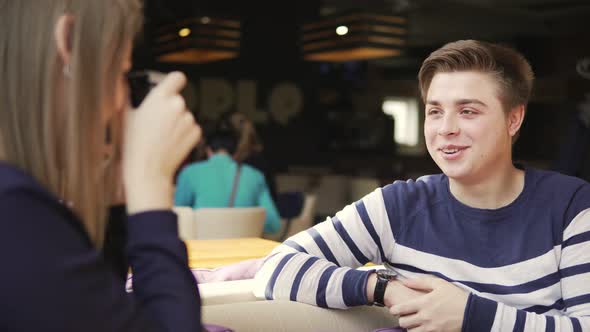 Young Couple Having Fun in Cafe