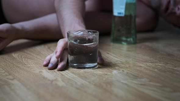 Slow Motion Alcoholic Falls to the Floor with Spilled Glass of Alcohol Overdose