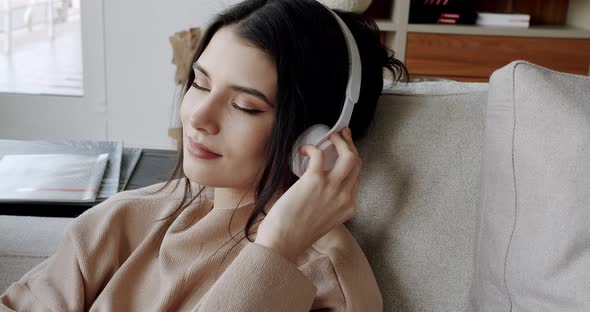 Mindful Young Happy Woman Wearing Wireless Headphones Listening Relaxing Music