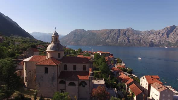 Church of the Our Lady Birth Against the Background of Buildings of Prcanj and the Kotor Bay