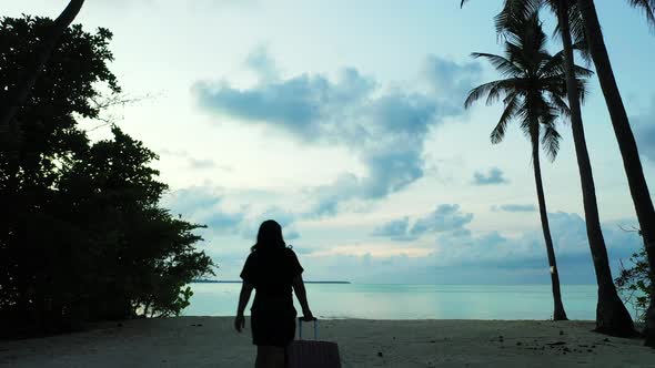 Modern Fun Woman Relaxing Spending Quality Time at The Beach on Clean White Sand and Blue