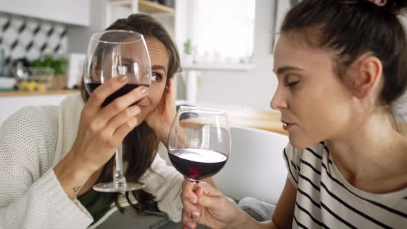 Zoom out video of two friends chatting and drinking wine. Shot with RED helium camera in 8K