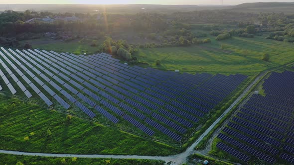 Ecology solar power station panels in the fields green energy at sunset landscape