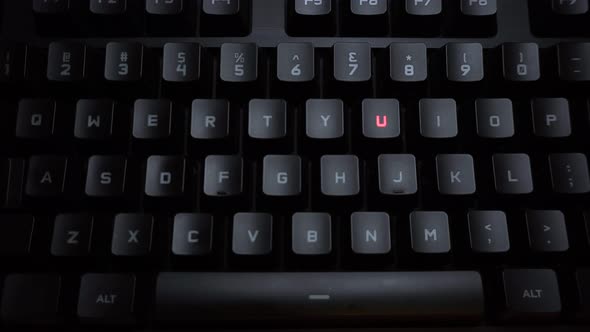 The Word Murder Is Typed on a Luminous Computer Keyboard. Black Backlit Keyboard with Letters. The