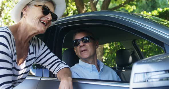 Senior couple interacting with each other in park