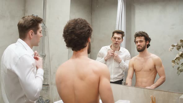 Young Athletic Gay Couple in Front of Mirror in Morning at Bathroom.