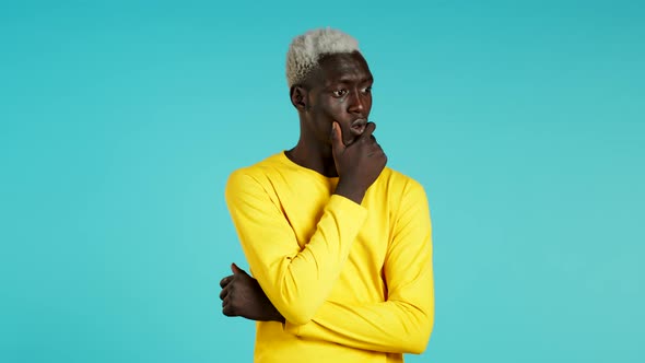 Portrait of Young African American Thinking Pondering Man Having Idea Moment Pointing Finger Up on