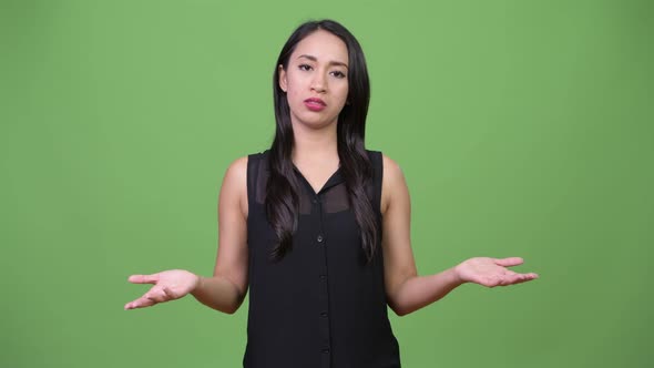 Young Beautiful Asian Businesswoman Shrugging Shoulders