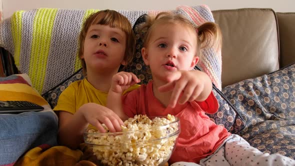 Kids Watching Movie with Popcorn Together