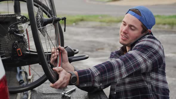 Disabled man assembling parts of a bicycle