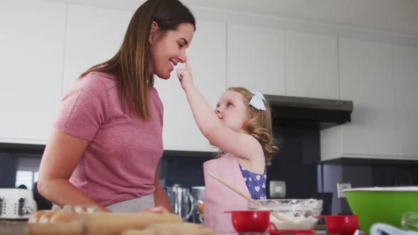 Caucasian mother and daughter having fun cooking together