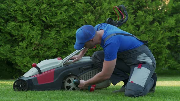 A Professional Repairman Repairs a Lawn Mower a Man Repairs a Mower in His Backyard