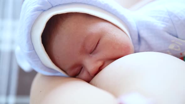 Woman Breastfeeding Newborn Baby