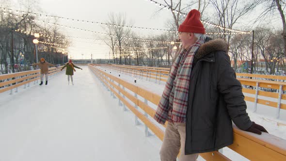 Senior Man Watching Couple Skating