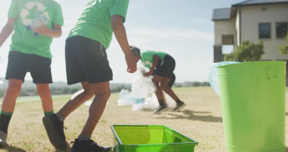 Video of diverse boys picking up trashes in front of school