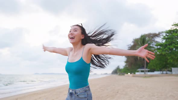 Asian young beautiful woman walking and running on beach during summer.