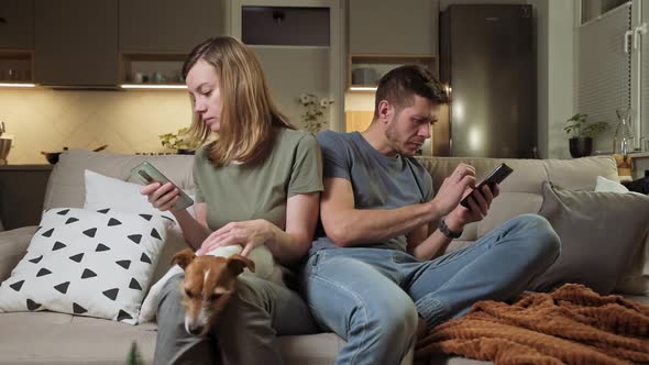 Family Couple Use Smartphones at Sofa