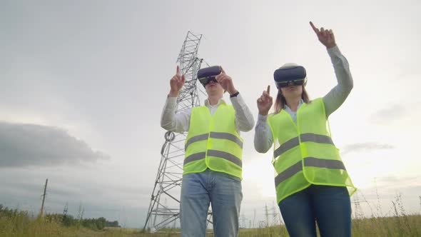 A Man and a Woman Engineer in VR Glasses Control the Power Distribution of Electric Networks and the