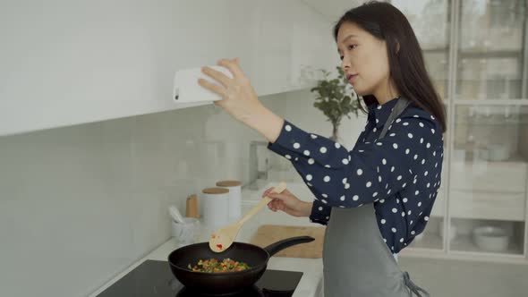 Young Asian Woman Blogger and Online Influencer Recording Video Content About Healthy Eating Frying