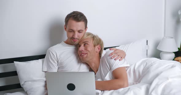 Loving Male Gay Couple Spend Time at Home Lying on Bed