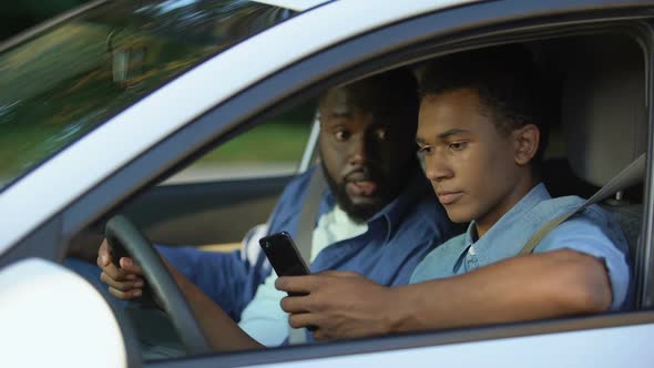 Auto Instructor Scolding Young Driver Chatting Smartphone Lesson, Safety Rules