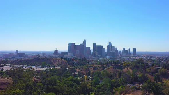 Panning left shot of Los Angeles, California skyline and ending in the parking lot of the Dodgers st