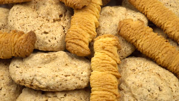 Dish of assorted cookies, including nut cookies and shortbread, background