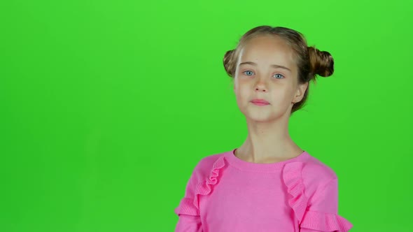 Child Girl Showing Thumbs Up and Making Faces. Green Screen