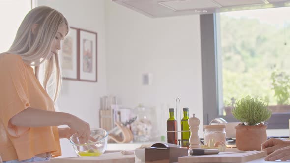 Woman Beating Whisking or Mixing Eggs