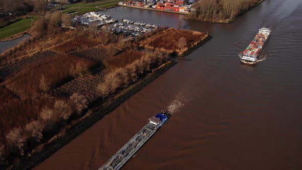 Drone View Of Two Ships Passing Marina Along River Noord. High Angle