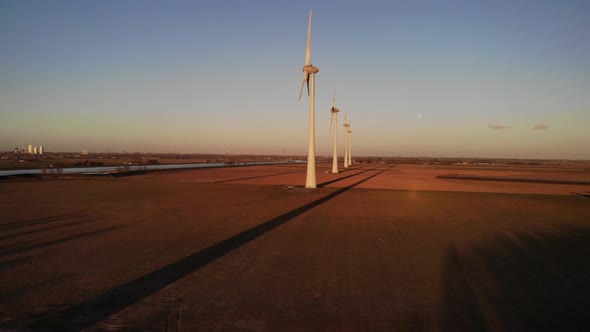 Towering Windmills On Green Fields Against Blue Sky At Dusk In Nieuw-Beijerland, Netherlands. - Pull