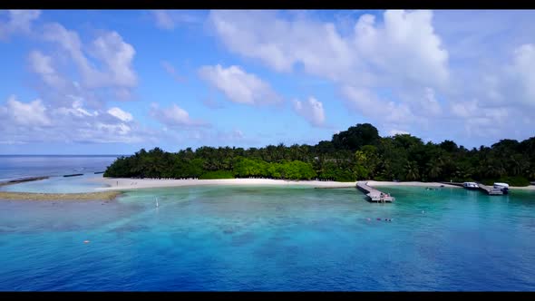 Aerial flying over sky of paradise island beach wildlife by transparent sea with white sand backgrou