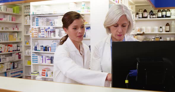 Pharmacists maintaining a record of medicine on computer
