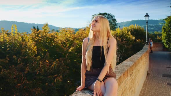 Blonde Lady Relaxing and Smiling in Sun Rays