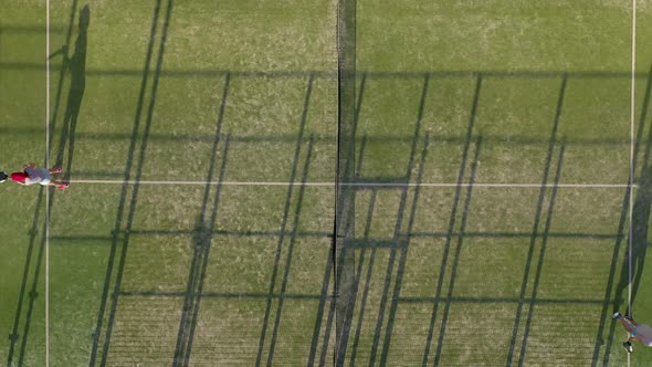 View From the Height of the Tennis Court Where People Warm Up Before the Game