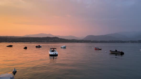 Aerial View of Colorful Sunset Scenery and Sunlight Reflection on Boats and Lake Water. Summer on La